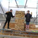 Enfants devant cheminée. Pierre Terre, maçonnerie du bâti ancien, éco-construction basée à Sens de Bretagne en Ille-et-Vilaine (35). Elle intervient principalement sur une zone géographique s’étendant entre Rennes et son agglomération, Combourg, Fougères et Saint Aubin du Cormier. Travail sur la terre (bauge, torchis, adobes) ou la pierre, ainsi que sur les enduits et d'autres prestations telles que les complexes de sol (hérisson isolé et non isolé, dalle de chaux, chape et terre cuite.